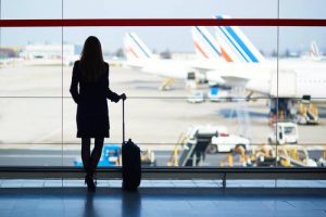 Photo Of A lady at the airport with a suitcase